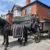 Horse drawn funeral carriage outside Carroll and Carroll funeral directors Leeds traditional funeral transport service